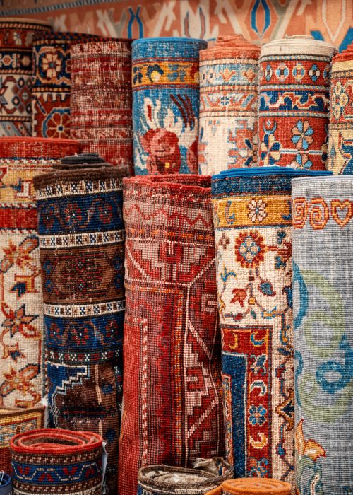 Multiple carpets at the Grand Bazaar in Istanbul, Turkey View of multiple carpets for sale at the Grand Bazaar in Istanbul, Turkey